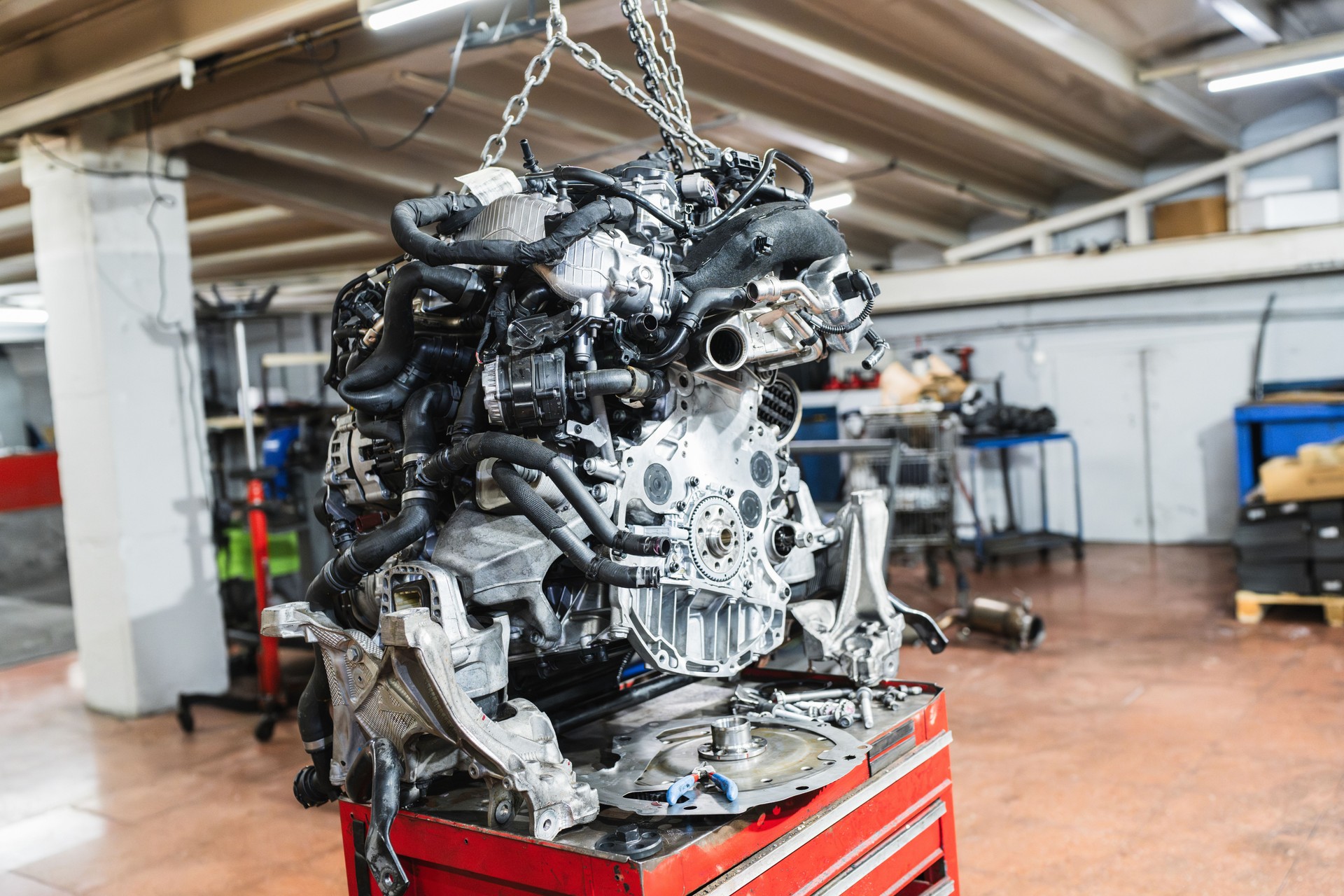 Car engine hanging in a repair shop